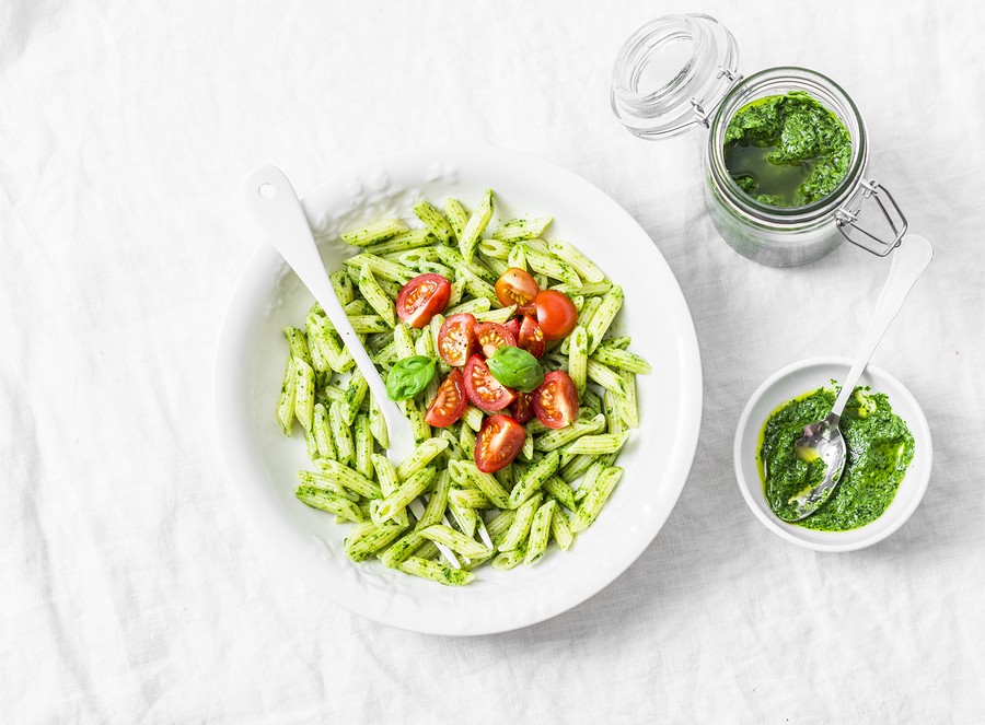 Pasta Penne With Arugula Pesto And Cherry Tomatoes On Light Background, Top View